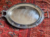 a silver tray sitting on a red rug on the floor