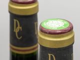 two bottles of wine sitting next to each other on top of a table