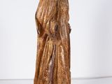 an old wooden statue of a woman in a golden dress
