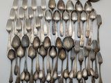 a lot of silver spoons and forks on the table