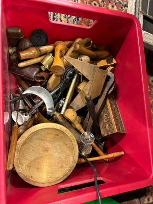 une boîte rouge posée par terre et remplie de divers outils