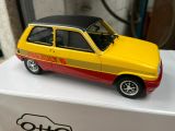 yellow and red toy car sitting on top of a white box