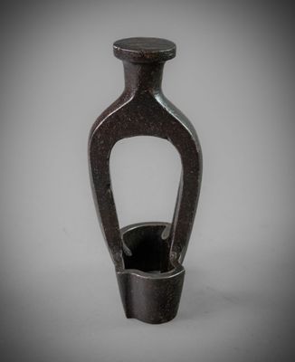 a black vase that is sitting on a table
