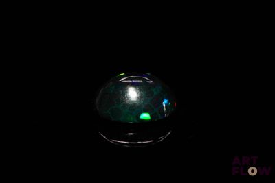 an oplite is glowing in the dark on a black surface
