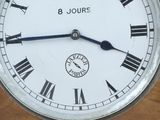 a clock with roman numerals on the face of it