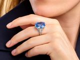 close up of a woman ' s hand with a ring on her finger