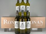 four bottles of wine in a wooden crate with a box behind them