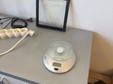 a desk with a lamp, a picture frame, and a picture on top of it