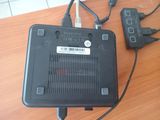 a small black device sitting on a table next to a charger