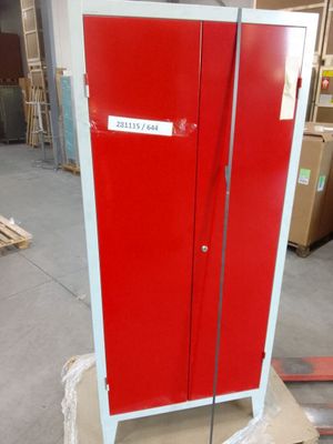 a red cabinet with a sign on it in a warehouse