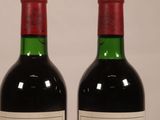 two bottles of wine that are sitting on a table