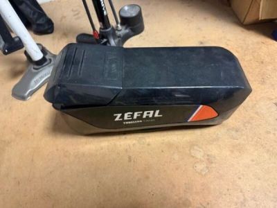 a black and orange scooter sitting on the floor