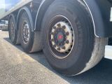 a flat tire on a semi truck parked on the side of the road