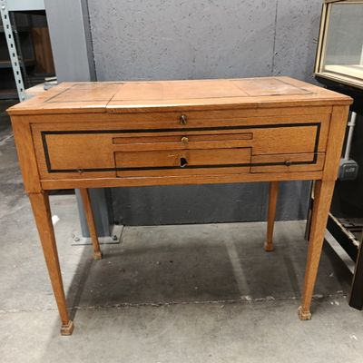 a small wooden table with two drawers on it