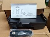 a black printer sitting on top of a cardboard box