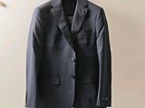 a suit hanging on a hanger on a wall
