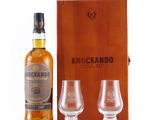 a wooden box with two glasses and a bottle of krockando