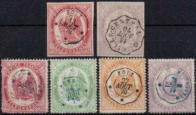 six different colored stamps on a black surface with a black background