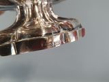 someone is holding a silver trophy in their hand on a glass table