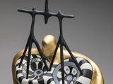 a black and white ceramic sculpture of a man and a woman