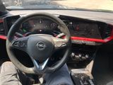 someone is sitting in the driver ' s seat of a car with their feet on the steering wheel