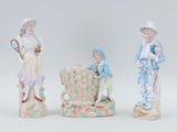 three porcelain figurines of children with baskets and a basket