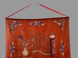 a red wall hanging with a chinese writing on it