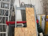 several pieces of plywood are stacked on top of each other in a garage