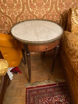 a small table with a marble top in a room