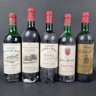 four bottles of wine are lined up on a table