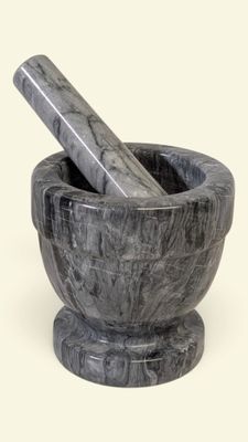 marble mortar and pestle with a wooden pestle in the middle