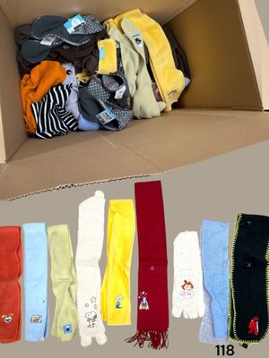 a cardboard box filled with assorted clothing and scarves
