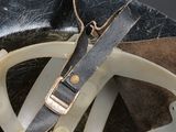 a close up of a helmet with a leather strap on it