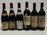 six bottles of wine are lined up in a row on a table