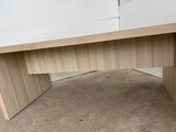 a close up of a wooden desk with a drawer underneath it