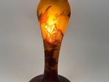 a lamp that is sitting on a table with a bird on it