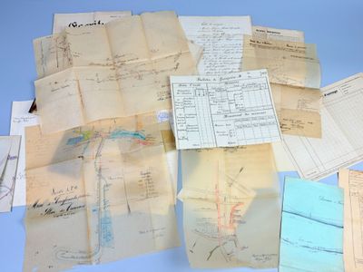 a pile of old papers on a blue surface