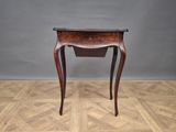 an old wooden table with a drawer on top of it