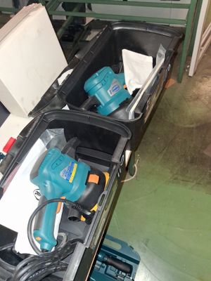two electric tools in a case on the floor
