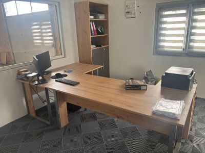 a desk with a laptop and a printer on it