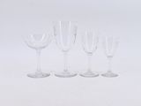 several empty wine glasses are lined up on a white surface