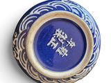 a blue and white vase with chinese writing on it