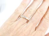 a woman ' s hand with a diamond ring on it