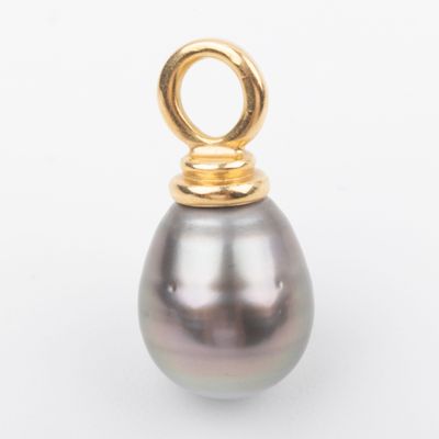 a close up of a black pearl pendant on a white surface