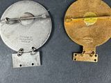 three different types of metal buttons on a black surface