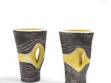 pair of black and yellow vases on a white background