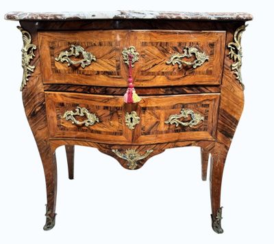 a wooden chest of drawers with a marble top