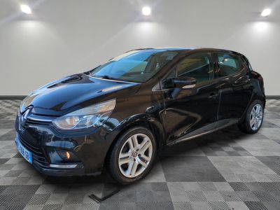 a black car parked in a garage with a checkered floor