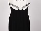 black and white dress on a mannequin display on a wooden stand