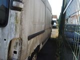 a white van that is parked in front of a fence